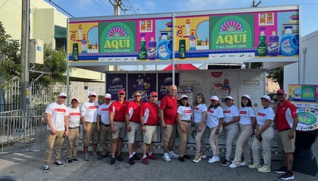 HAP event team lined up in front of the Colgate-Palmolive pavilion at Miami's Calle Ocho festival