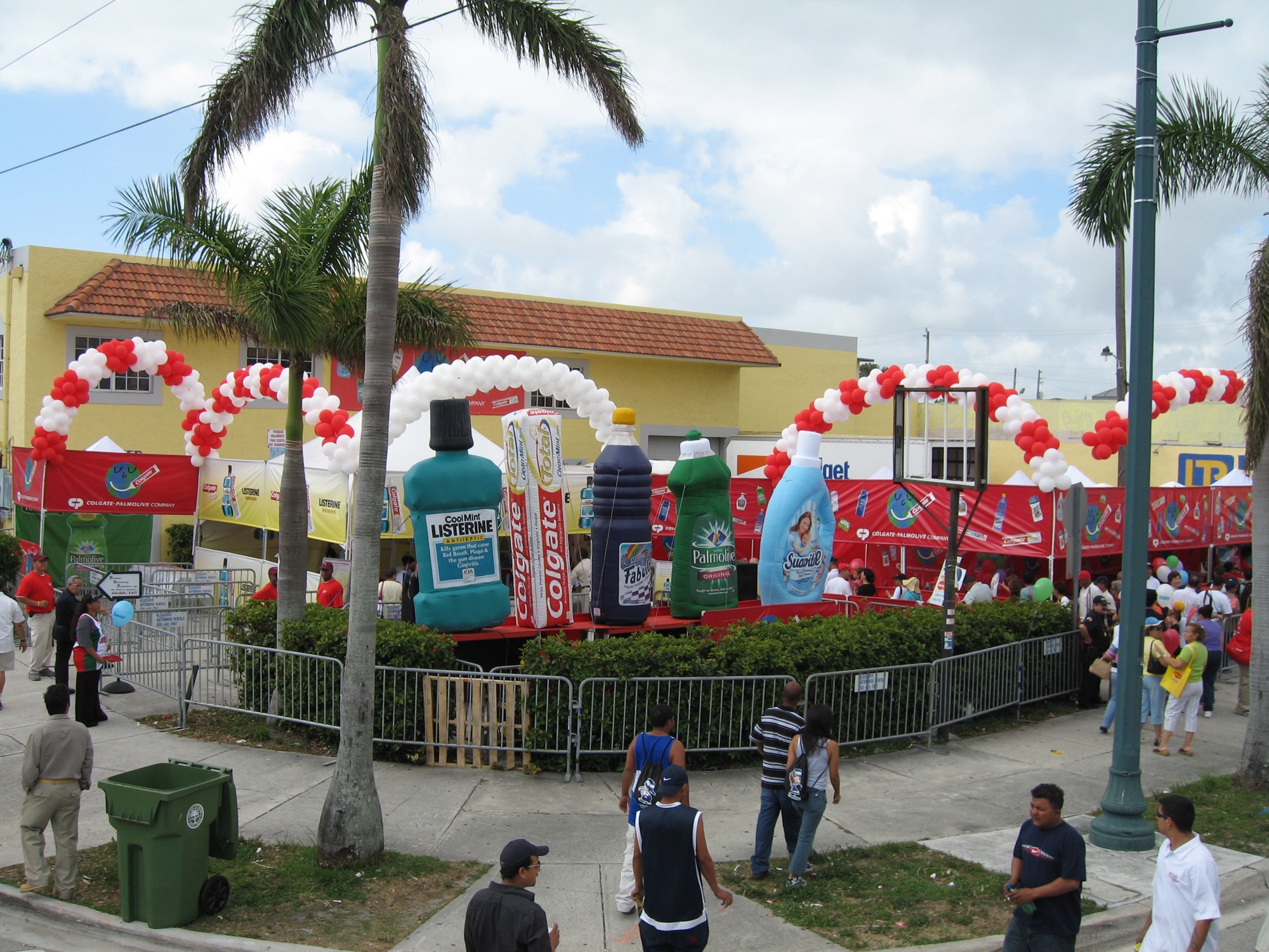 Giant inflatable Colgate-Palmolive product replicas and branded tents at an outdoor street festival
