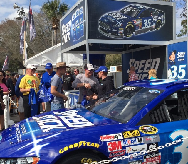 Speed Stick branded race car and display booth drawing a crowd at an outdoor event